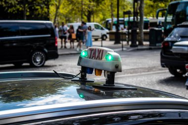 Paris, France - September 05, 2022 Taxi driving through the streets of Paris, This mode of transport is famous and widely used by Parisians and tourists, several companies compete in the city of Paris