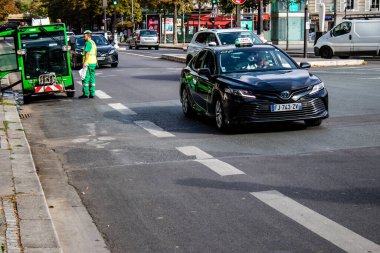 Paris, France - September 05, 2022 Taxi driving through the streets of Paris, This mode of transport is famous and widely used by Parisians and tourists, several companies compete in the city of Paris