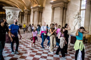 Paris, Fransa - 08 Eylül 2022 Dünyanın en büyük müzesi Louvre, sanat için ikonik bir yer, ziyaretçiler mermer heykellere ve usta resimlere hayran olmak için koridorlarda dolaşıyorlar.