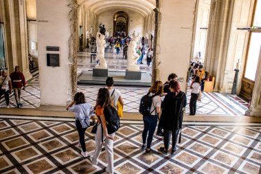 Paris, Fransa - 08 Eylül 2022 Dünyanın en büyük müzesi Louvre, sanat için ikonik bir yer, ziyaretçiler mermer heykellere ve usta resimlere hayran olmak için koridorlarda dolaşıyorlar.