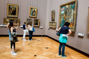 Paris, Fransa - 08 Eylül 2022 Dünyanın en büyük müzesi Louvre, sanat için ikonik bir yer, ziyaretçiler mermer heykellere ve usta resimlere hayran olmak için koridorlarda dolaşıyorlar.