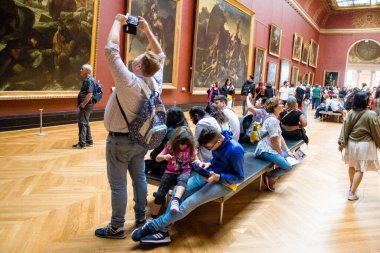 Paris, Fransa - 08 Eylül 2022 Dünyanın en büyük müzesi Louvre, sanat için ikonik bir yer, ziyaretçiler mermer heykellere ve usta resimlere hayran olmak için koridorlarda dolaşıyorlar.