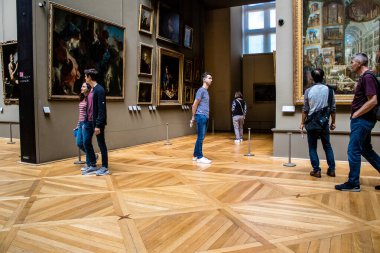 Paris, Fransa - 08 Eylül 2022 Dünyanın en büyük müzesi Louvre, sanat için ikonik bir yer, ziyaretçiler mermer heykellere ve usta resimlere hayran olmak için koridorlarda dolaşıyorlar.