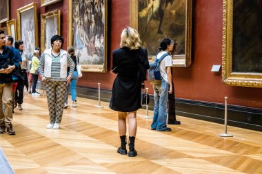 Paris, Fransa - 08 Eylül 2022 Dünyanın en büyük müzesi Louvre, sanat için ikonik bir yer, ziyaretçiler mermer heykellere ve usta resimlere hayran olmak için koridorlarda dolaşıyorlar.