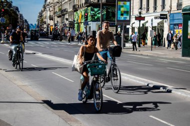 Paris, Fransa - 12 Eylül 2022 Sokaklarda bisiklet kullanan insanlar, Parisliler ve turistler tarafından yaygın olarak kullanılıyor, başkentte bu ulaşım modelini desteklemek için birçok bisiklet yolu mevcuttur
