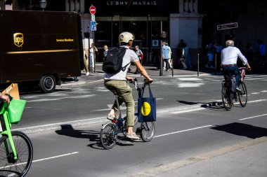 Paris, Fransa - 12 Eylül 2022 Sokaklarda bisiklet kullanan insanlar, Parisliler ve turistler tarafından yaygın olarak kullanılıyor, başkentte bu ulaşım modelini desteklemek için birçok bisiklet yolu mevcuttur