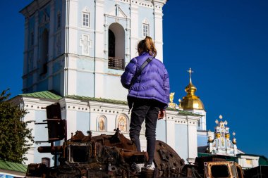 Ukrayna, Kyiv 'deki Mykhailivska Meydanı' ndaki imha edilmiş Rus askeri teçhizatı sergisinde, 16 Ekim 2022 Ukraynalı çocuklar imha edilmiş Rus askeri teçhizatıyla eğleniyorlar, bunu bir oyun grubu olarak kullanıyorlar.