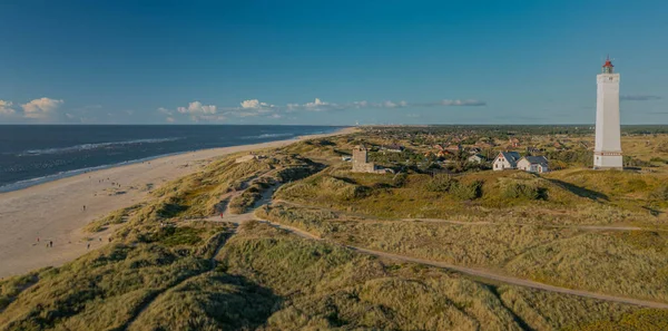 Panoramic view of Blvand lighthouse on wide dune of Blvandshuk with beach view on the west coast of Jutland, by Esbjerg, Denmark. 