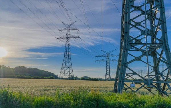 Power line, power supply with countryside landscape. Electricity grid expansion for the energy transition. Electricity pylons.