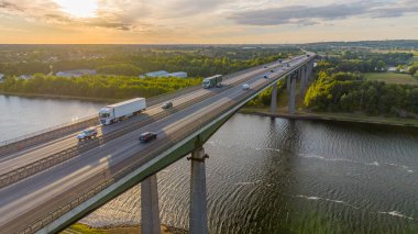 Transport traffic with big trucks and cars on the highway brigde. Transportation of goods with lorry. Road freight transportation. The Rader Hochbrcke crosses the A 7 federal motorway with traffic. 