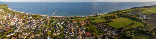Panorama aerial view of Baltic sea resort Kellenhusen with its famous pier, Schleswig-Holstein, Germany. Kellenhusen Baltic sea resort and its surrounds with campsite at the Baltic seaside.