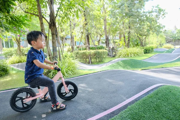 A Boy riding his bicycle on a pump track, Bike Park, Thailand