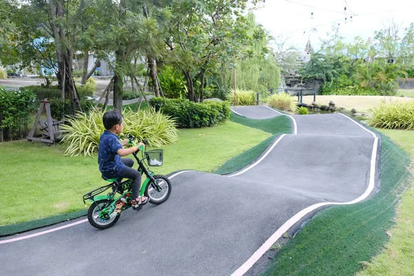 A Boy riding his bicycle on a pump track, Bike Park, Thailand