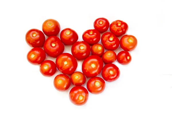Fresh tomatoes stacked in the form of heart Royalty Free Stock Images