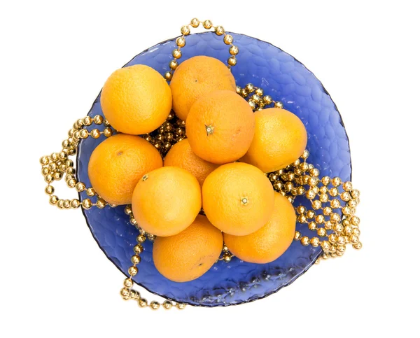 Tangerines and Christmas tree ornaments on a blue plate — Stock Photo, Image