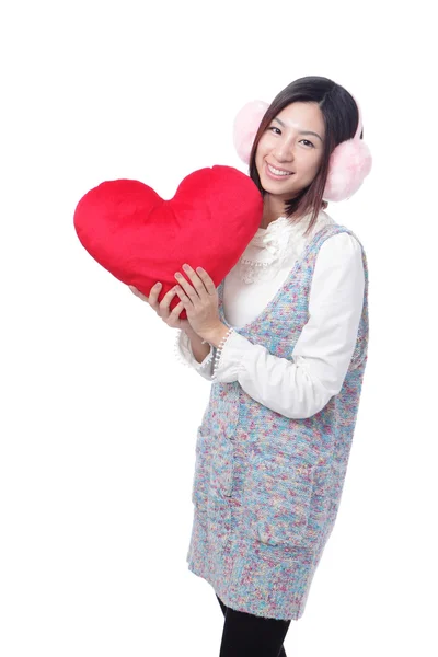 Woman dressed in warm clothes with love pillow — Stock Photo, Image