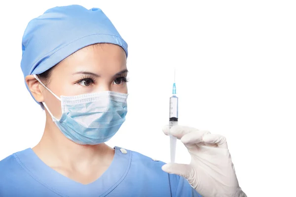 Surgery woman doctor look syringe needle — Stock Photo, Image