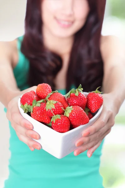 Beautiful woman showing fresh strawberries — Stock Photo, Image