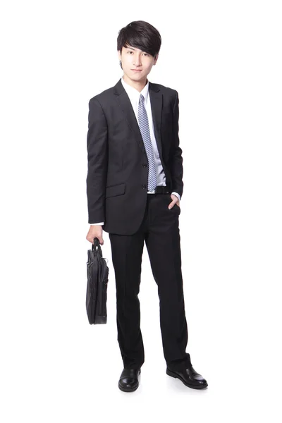 Uomo d'affari in piedi e in possesso di valigetta — Foto Stock