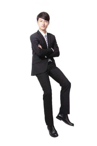 Successful business man sitting on something — Stock Photo, Image