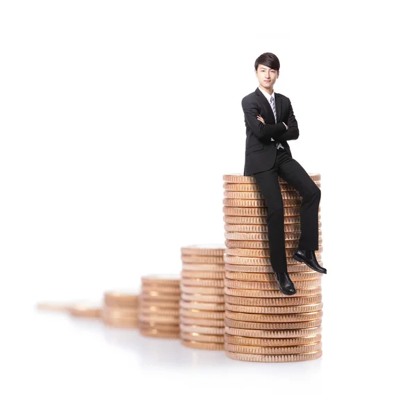 Successful business man sitting on money stairs — Stock Photo, Image