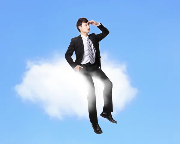 Business man sitting on a cloud — Stock Photo, Image