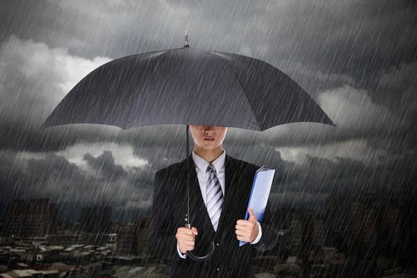 Businessman under heavy rain — Stock Photo, Image
