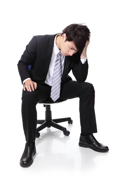 Frustrated and thinking business man sitting — Stock Photo, Image