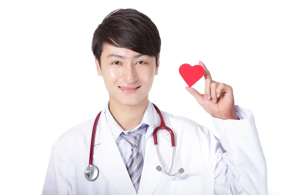 Doctor sosteniendo una almohada roja del corazón del amor —  Fotos de Stock