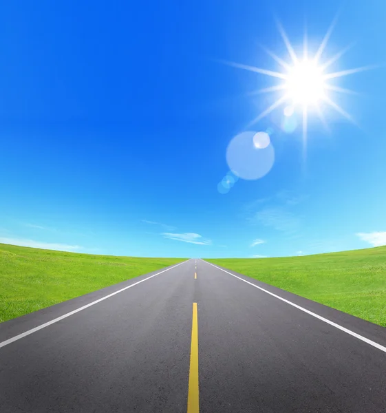 Estrada de asfalto com céu nublado e luz solar — Fotografia de Stock