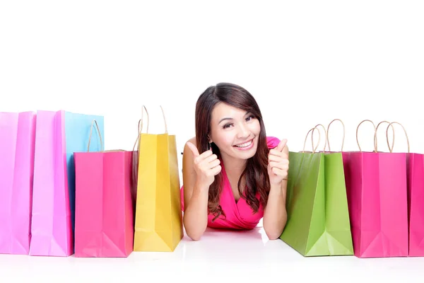 Young girl lying with shopping bags — Stock Photo, Image