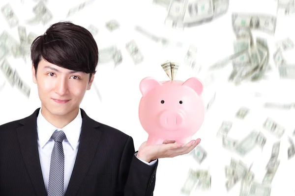 Business man holding pink piggy bank — Stock Photo, Image