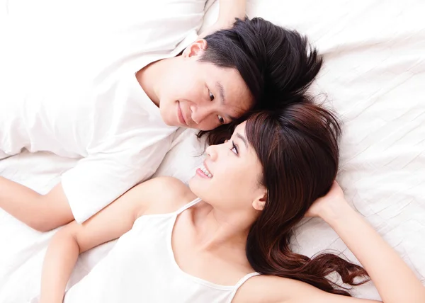 Couple happy smile looking to each other in bed — Stock Photo, Image