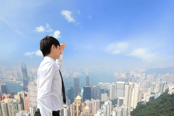 Successful business man looking away with city — Stock Photo, Image