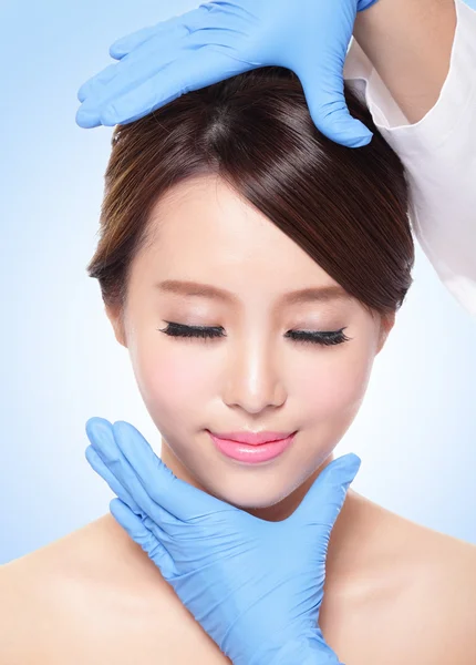 Beautiful female face with Plastic surgery glove — Stock Photo, Image