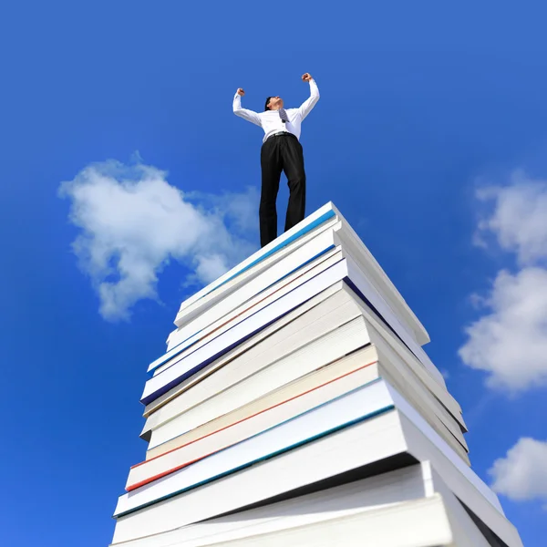 Excited business man arise arm cheering and celebrating on a stack Of Books — Stock Photo, Image