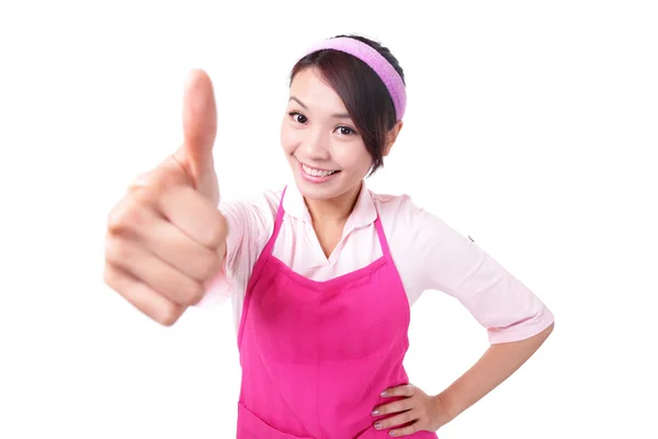 Gelukkig jonge vrouw huisvrouw keuken schort dragen en duimen opdagen — Stockfoto