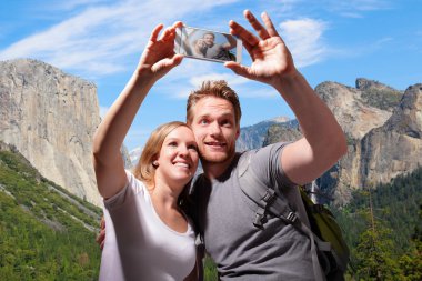 Happy couple selfie in yosemite clipart