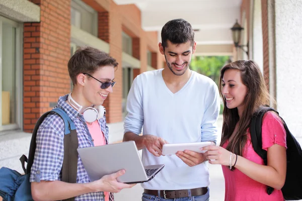 Happy College students using computer — Stock Photo, Image