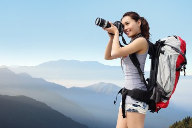 Woman mountain hiker taking pictures clipart