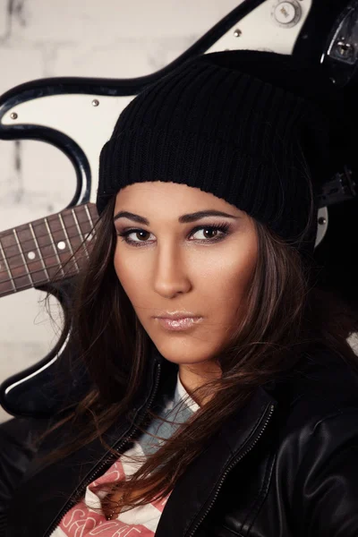 Portrait of young beautiful woman musician holding her guitar on her shoulder — Stock Photo, Image