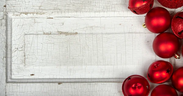 Red Christmas ornaments on wood panel — Stock Photo, Image