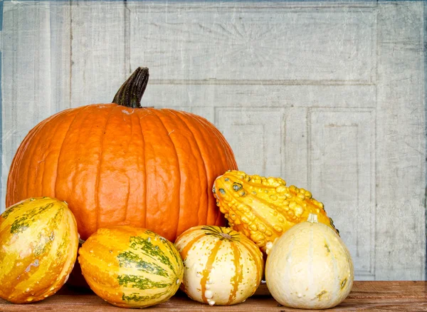 Pumpkins and gourds on a crate — Stock Photo, Image