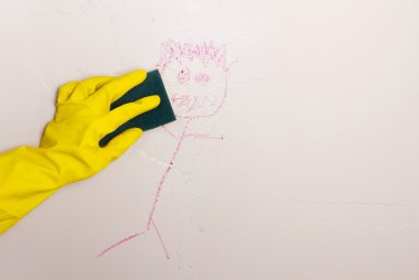 Cleaning crayon off wall with sponge clipart