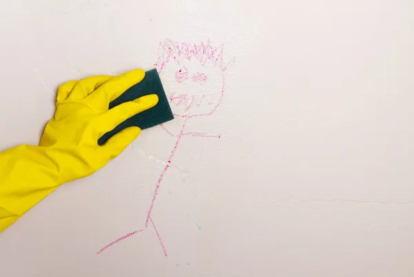 Cleaning crayon off wall with sponge — Stock Photo, Image