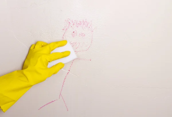 Cleaning crayon off wall with magic eraser — Stock Photo, Image