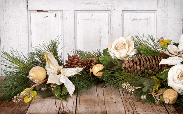 Christmas flowers and pine branches on wood — Stock Photo, Image