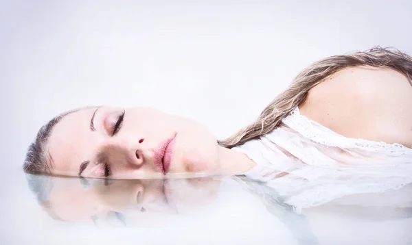 Woman in water with reflection — Stock Photo, Image