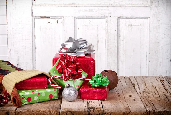 Christmas presents spilling out of a stocking — Stock Photo, Image