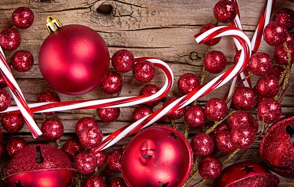 Candy canes and ornaments on wood — Stock Photo, Image